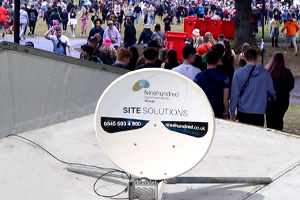 Satellite dish in front of crowd