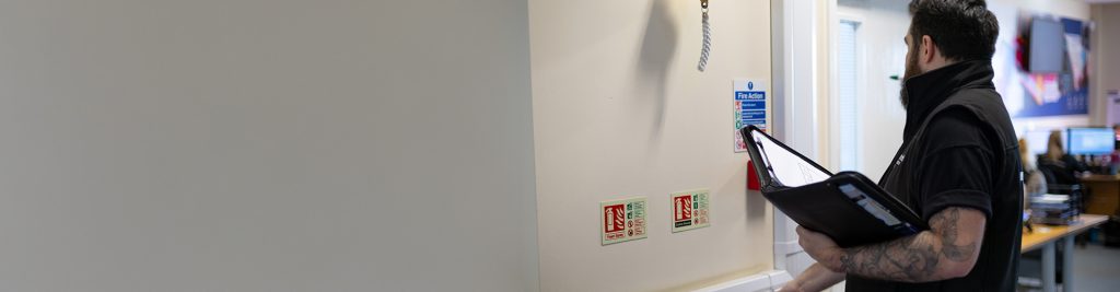 a fire extinguisher and fire hose on a wall