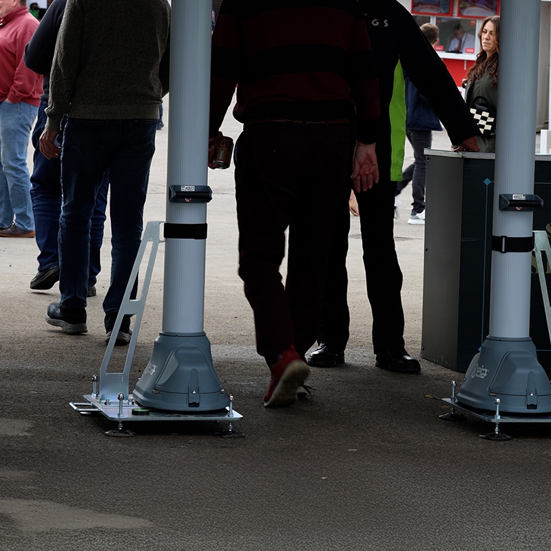 a group of people walking through a 900opengate metal detector