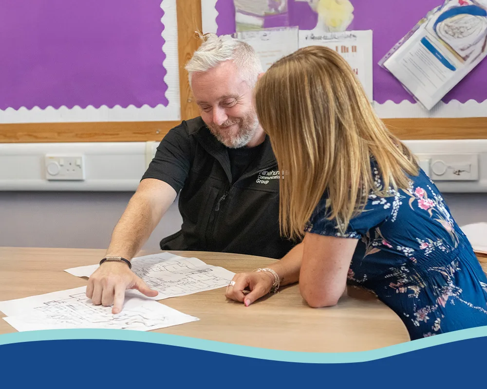 teacher with staff member looking at school plans