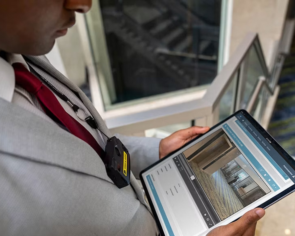 Man reviewing body camera footage on tablet