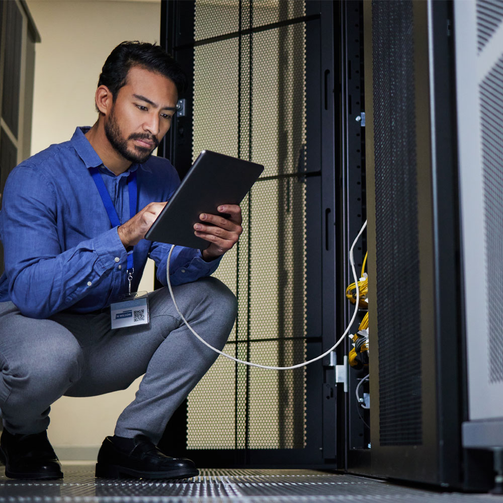 a man connecting his ipad to a junction box