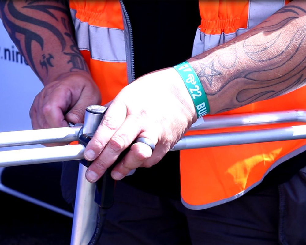 a man in an orange vest fixing somthing