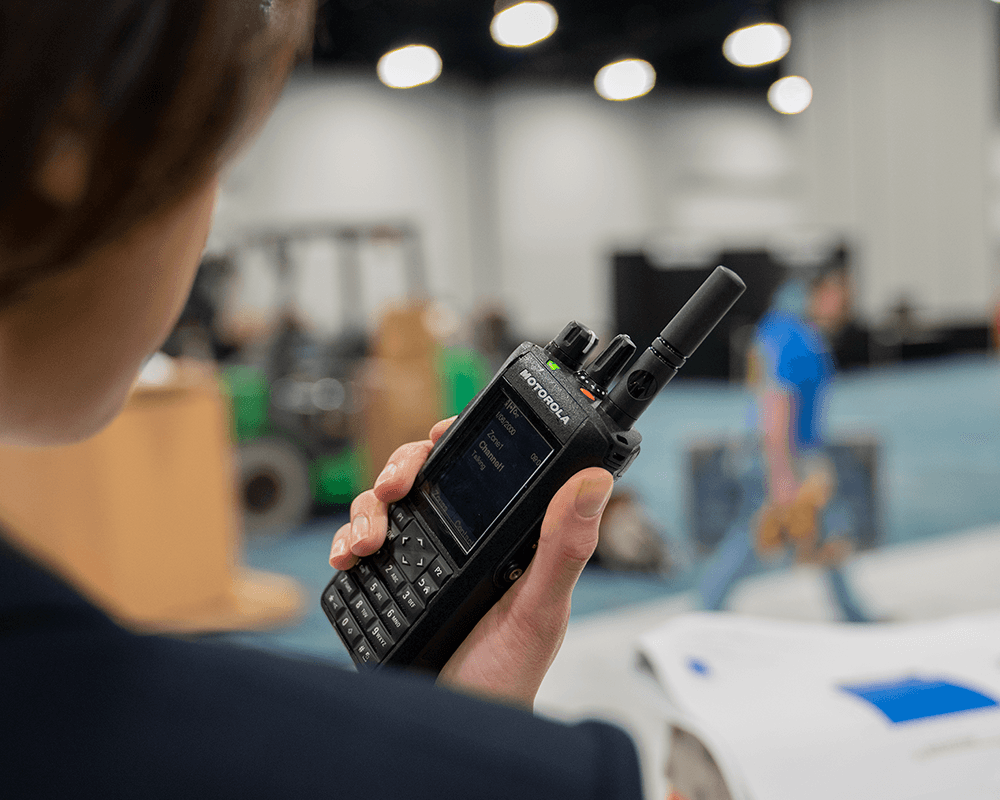 Person using a Motorola radio device.